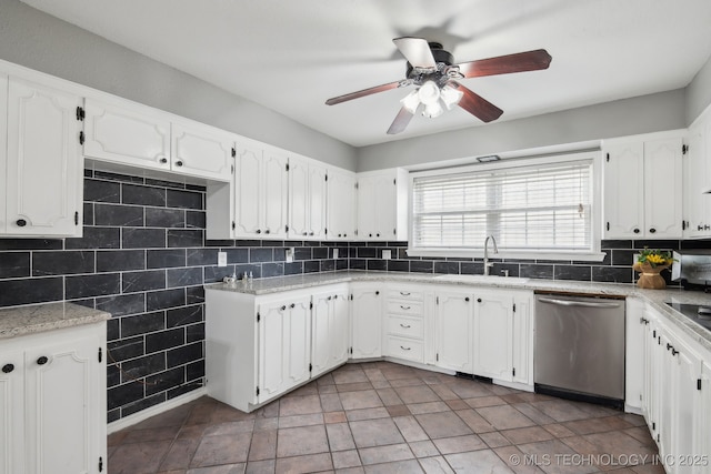 201 Sandy Cir, Tahlequah, OK 74464 - kitchen featuring stainless steel dishwasher, a sink, a ceiling fan, white cabinetry, and decorative backsplash