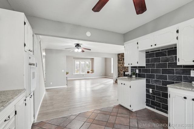 201 Sandy Cir, Tahlequah, OK 74464 - kitchen with ceiling fan, white cabinets, open floor plan, wood finished floors, and white oven