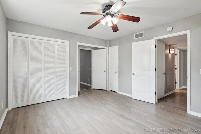 unfurnished bedroom with a closet, ceiling fan, and light wood-type flooring