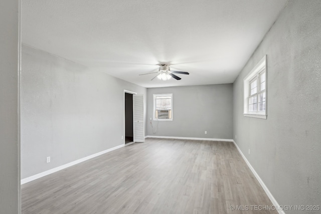 201 Sandy Cir, Tahlequah, OK 74464 - unfurnished room with ceiling fan, healthy amount of natural light, light wood-style flooring, and baseboards