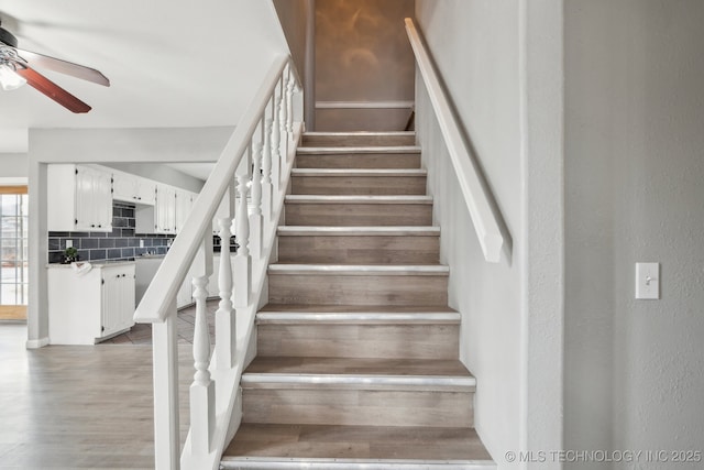 201 Sandy Cir, Tahlequah, OK 74464 - stairs featuring a ceiling fan and wood finished floors
