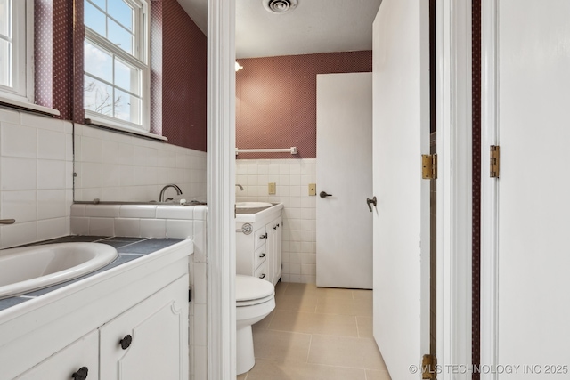 201 Sandy Cir, Tahlequah, OK 74464 - bathroom with vanity, tile walls, tile patterned floors, wallpapered walls, and toilet