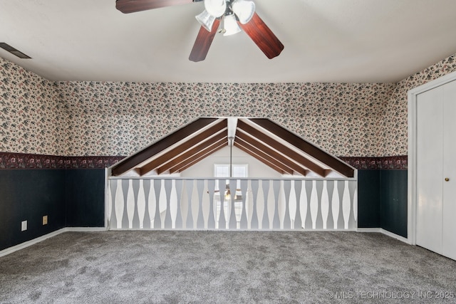 bonus room with lofted ceiling, ceiling fan, and carpet