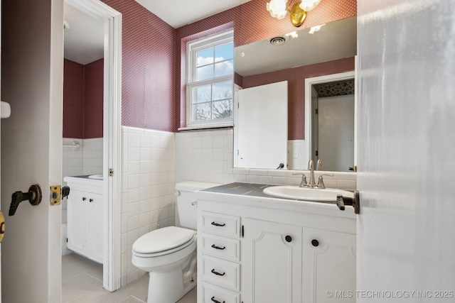 201 Sandy Cir, Tahlequah, OK 74464 - bathroom featuring wallpapered walls, vanity, toilet, tile patterned flooring, and tile walls