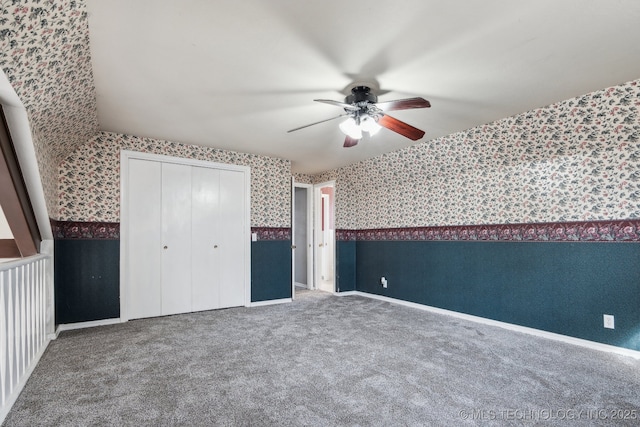 unfurnished bedroom featuring carpet flooring, ceiling fan, and a closet