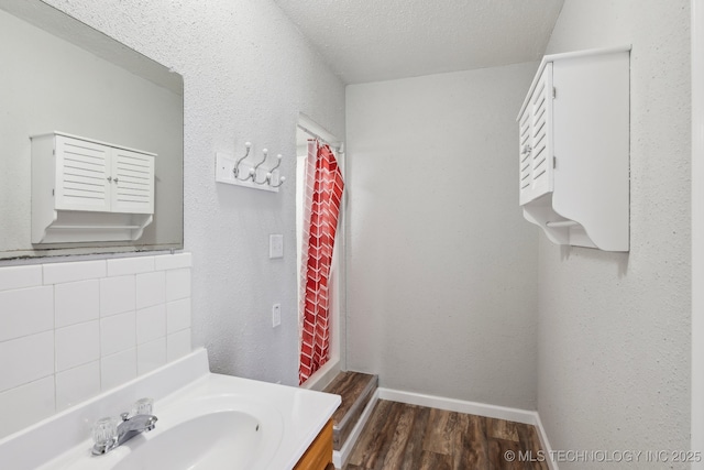 201 Sandy Cir, Tahlequah, OK 74464 - bathroom featuring vanity, wood finished floors, baseboards, and a textured ceiling