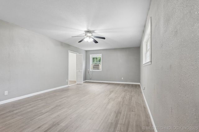 201 Sandy Cir, Tahlequah, OK 74464 - unfurnished room with a ceiling fan, light wood-style floors, baseboards, and cooling unit