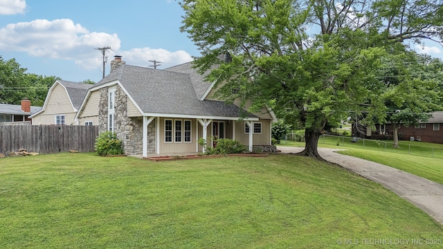 201 Sandy Cir, Tahlequah, OK 74464 - view of front facade featuring stone siding, roof with shingles, and a chimney