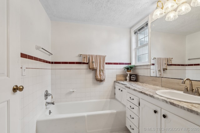 201 Sandy Cir, Tahlequah, OK 74464 - bathroom with a bath, tile walls, vanity, and a textured ceiling
