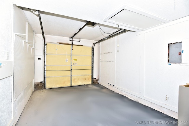 garage featuring electric panel and a garage door opener