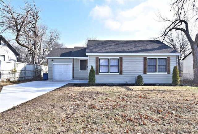 ranch-style home featuring a garage and a front lawn