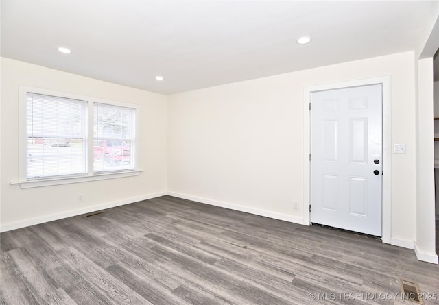 spare room featuring dark hardwood / wood-style flooring