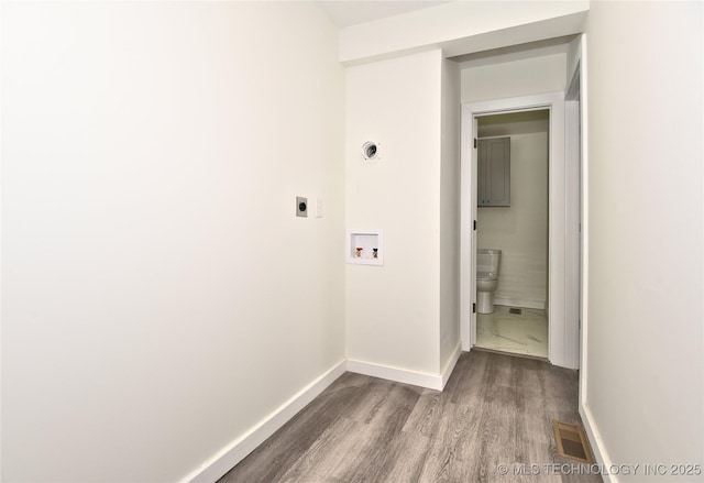 hallway with hardwood / wood-style floors