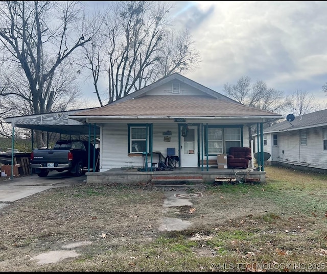 view of front of house with a porch and a carport