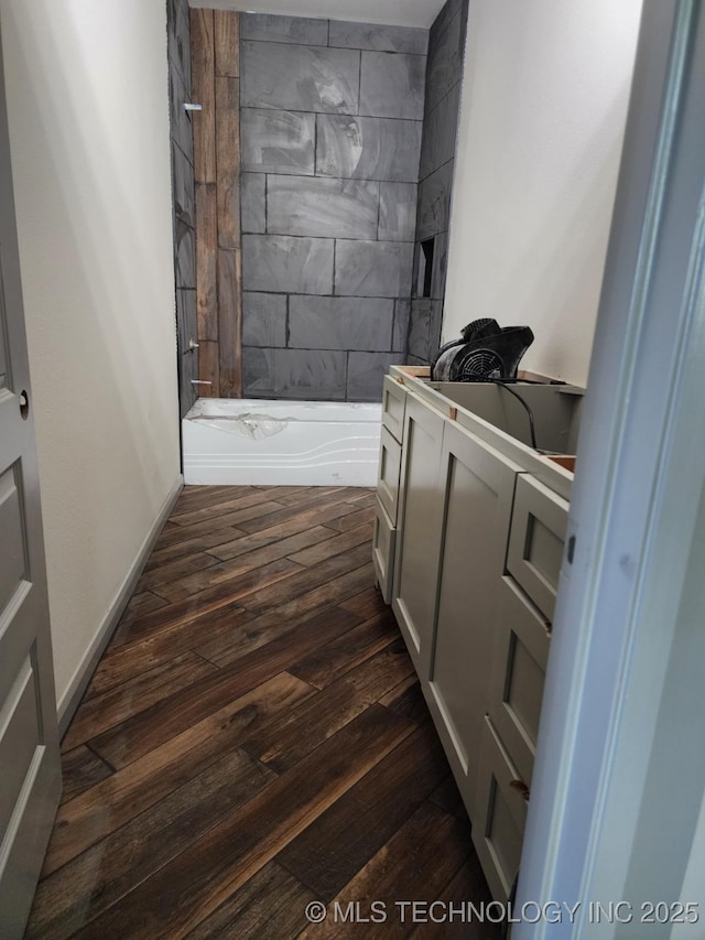 bathroom featuring hardwood / wood-style floors and tiled shower / bath combo