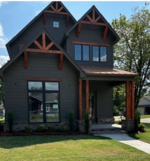 view of front of property with a front yard and covered porch