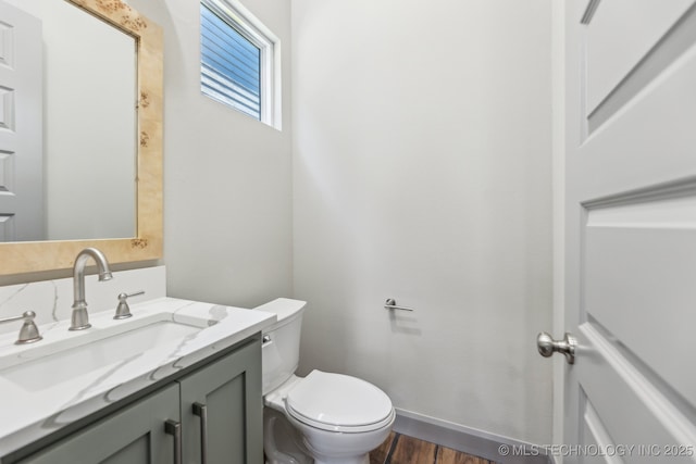 425 W Ft Worth St, Broken Arrow, OK 74012 - bathroom featuring wood finished floors, toilet, and vanity