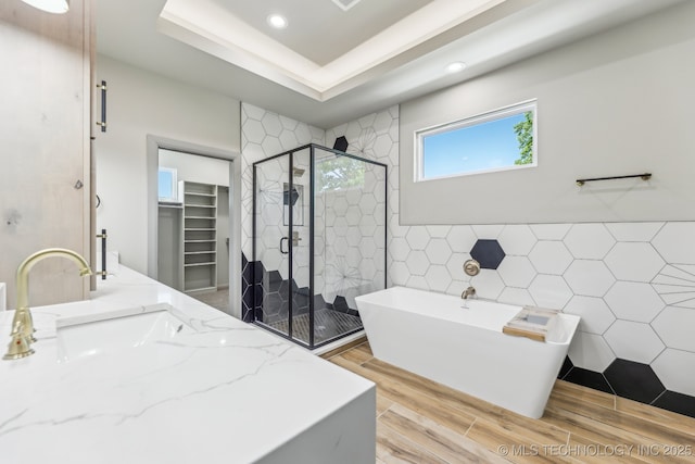 425 W Ft Worth St, Broken Arrow, OK 74012 - full bathroom featuring a shower stall, wood finished floors, a freestanding tub, tile walls, and recessed lighting