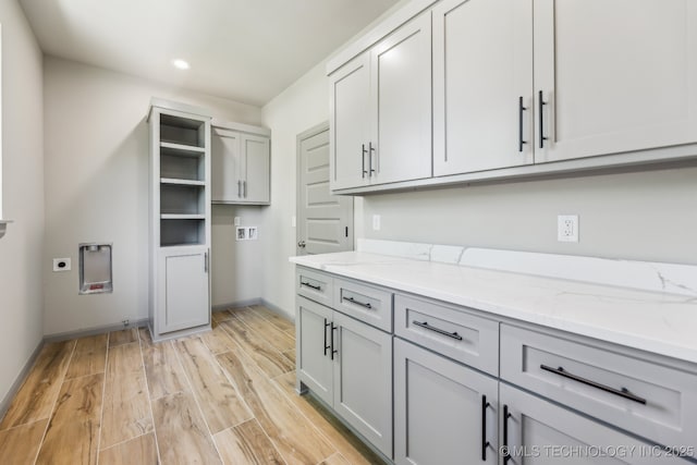425 W Ft Worth St, Broken Arrow, OK 74012 - washroom featuring light wood-style flooring, hookup for an electric dryer, recessed lighting, hookup for a washing machine, and cabinet space