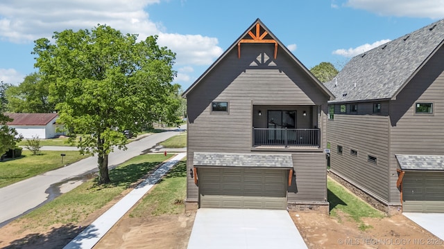 425 W Ft Worth St, Broken Arrow, OK 74012 - view of front of home with an attached garage, a balcony, and concrete driveway