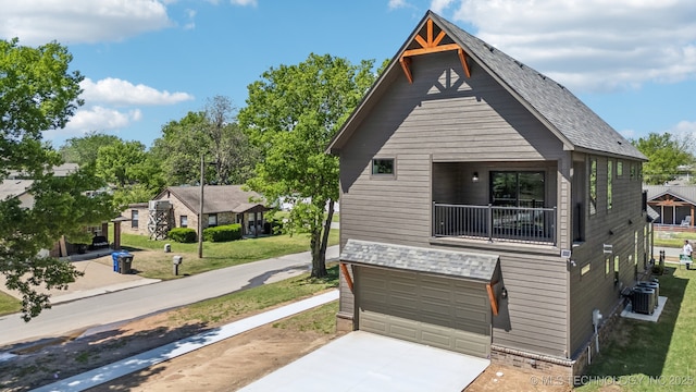 425 W Ft Worth St, Broken Arrow, OK 74012 - view of front facade with a balcony, central AC, an attached garage, driveway, and a front yard