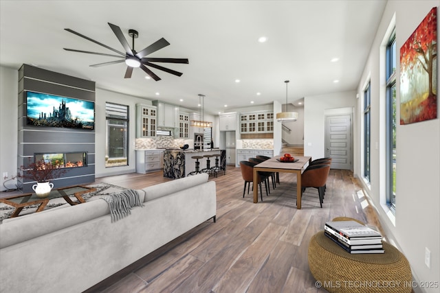 425 W Ft Worth St, Broken Arrow, OK 74012 - living room with stairway, wood finished floors, a multi sided fireplace, ceiling fan, and recessed lighting