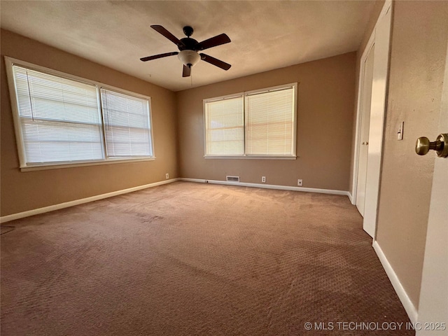 empty room with carpet and ceiling fan