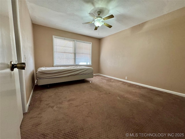 unfurnished bedroom with a textured ceiling, ceiling fan, and carpet flooring