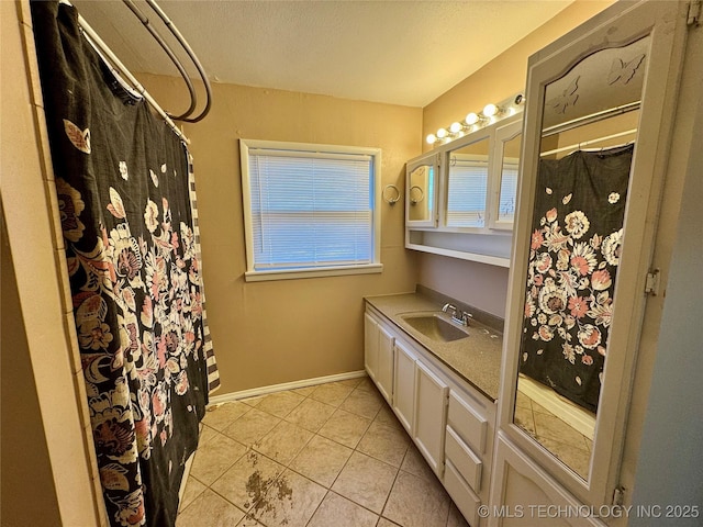 bathroom featuring tile patterned flooring and vanity