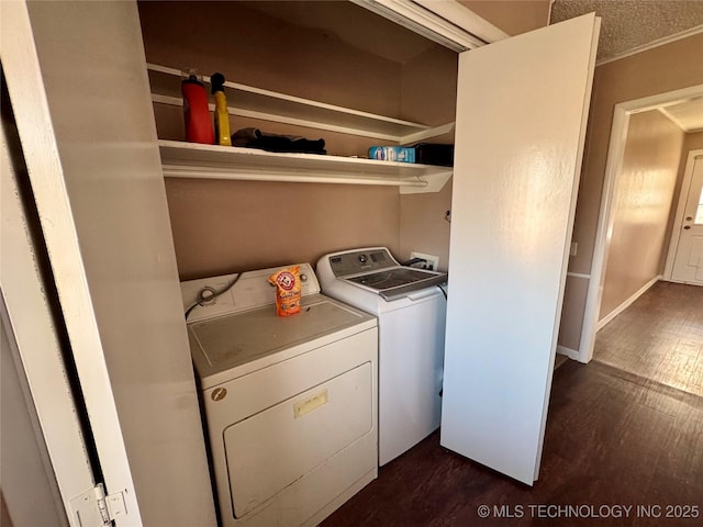 laundry room with dark wood-type flooring and washing machine and dryer