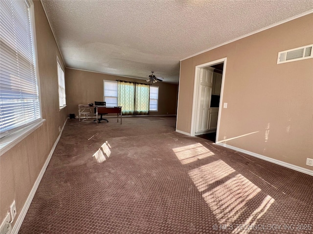 interior space with carpet floors, a textured ceiling, ornamental molding, and ceiling fan