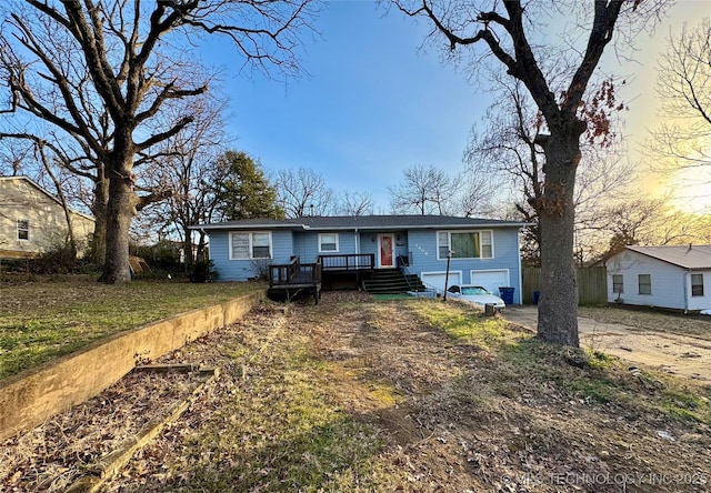 view of front of property with a garage and a wooden deck