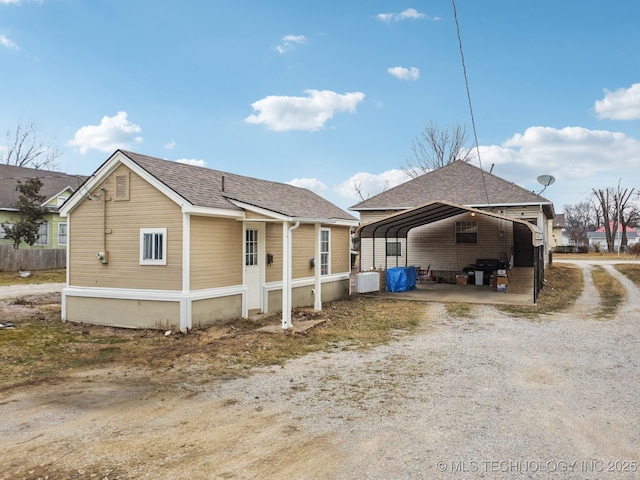 view of side of property with a carport