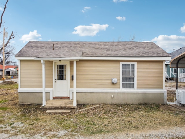 back of house with a carport