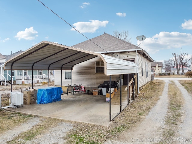 view of parking / parking lot featuring a carport