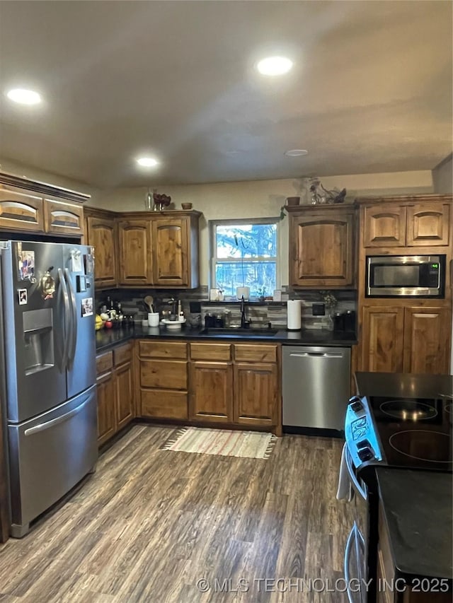 kitchen with dark hardwood / wood-style flooring, sink, and appliances with stainless steel finishes