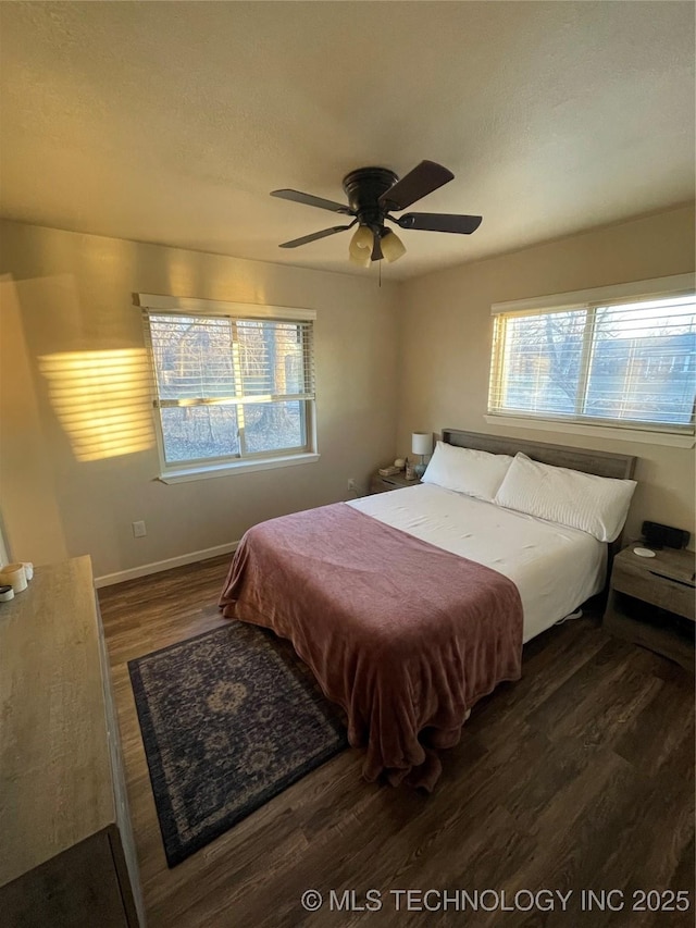 bedroom with dark hardwood / wood-style floors and ceiling fan