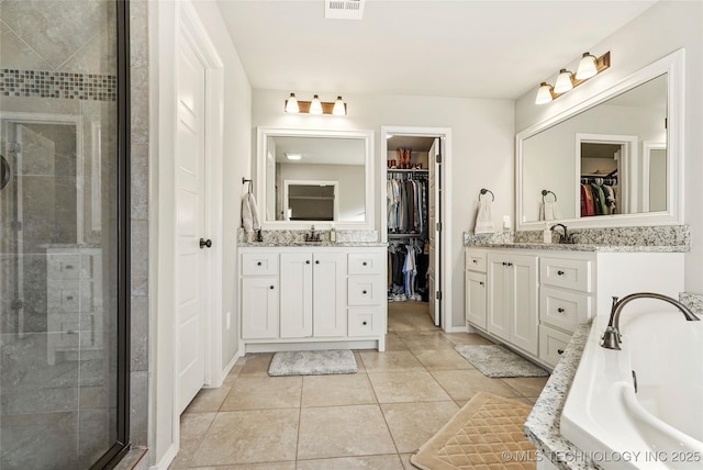 bathroom with tile patterned flooring, vanity, and an enclosed shower