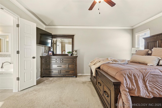 carpeted bedroom with ceiling fan, ornamental molding, and ensuite bath