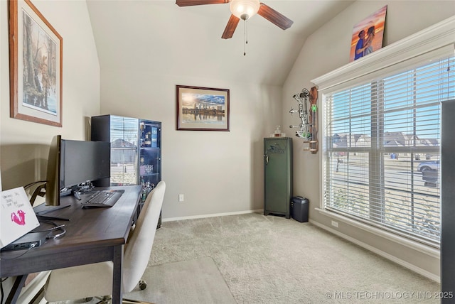 carpeted home office featuring ceiling fan and vaulted ceiling