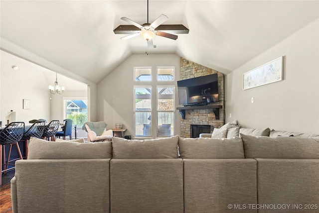 living room with dark hardwood / wood-style flooring, lofted ceiling, a fireplace, and ceiling fan with notable chandelier