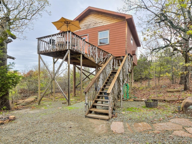 rear view of property featuring a deck