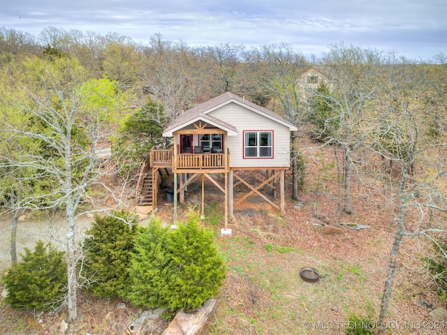 rear view of house featuring a deck