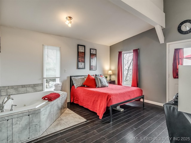 bedroom with vaulted ceiling with beams