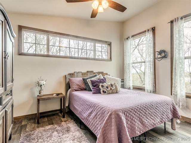 bedroom with dark hardwood / wood-style flooring, ceiling fan, and lofted ceiling