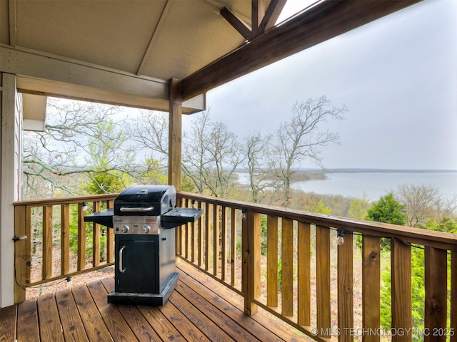 wooden deck featuring a grill and a water view