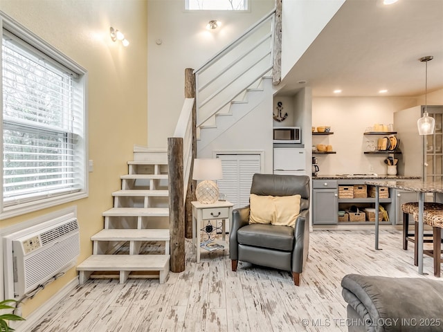 interior space featuring hardwood / wood-style floors and a wall mounted air conditioner