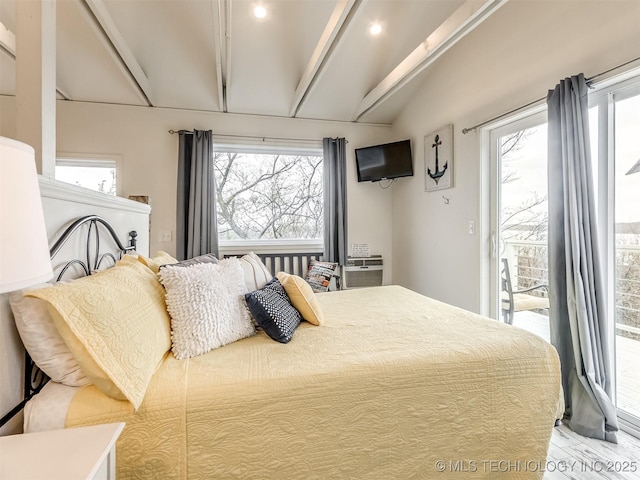 bedroom featuring lofted ceiling, access to outside, and multiple windows