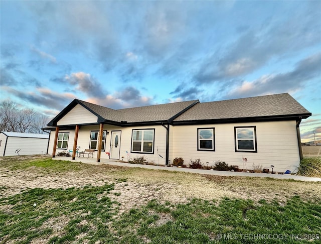 single story home featuring a patio and a front lawn