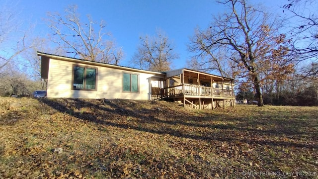 rear view of property featuring a deck